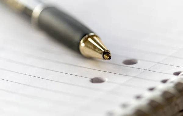 Closeup of a pencil on a writing pad. Very short depth of focus