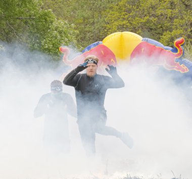 Stockholm, İsveç - 14 Mayıs 2016: Siyah elbiseli üstünden atlayarak erkeklerde ateş ve engel yarışta zor Viking olay İsveç ' te 14 Nisan 2016 duman