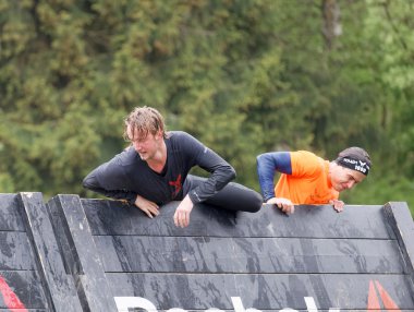 Stockholm, İsveç - 14 Mayıs 2016: Erkekler 14 Mayıs 2016 'da İsveç' te Zorlu Viking Etkinliği 'nde engel yarışında tahtaya tırmanıyor