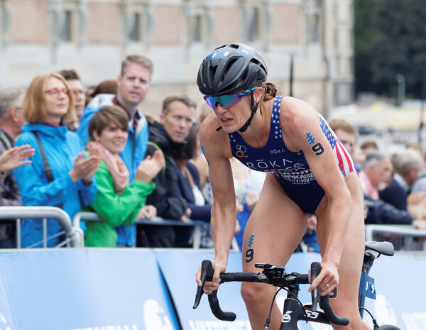 STOCKHOLM - JUL 02, 2016: FFemale triathlete Katie Zaferes (USA) cycling uphill, audience clapping in the Women's ITU World Triathlon series event July 02, 2016 in Stockholm, Sweden