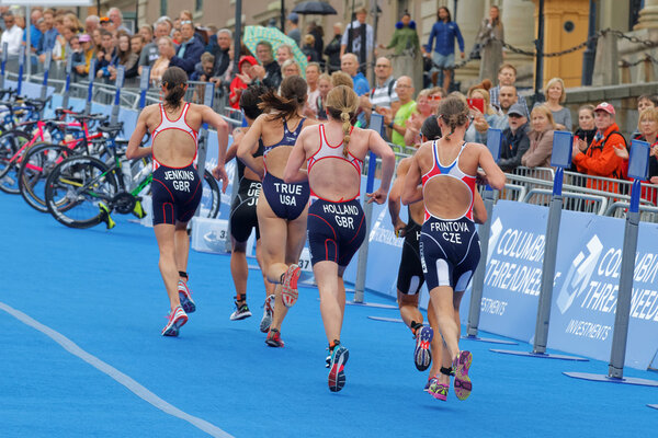 STOCKHOLM - JUL 02, 2016: Rear view of group of running triathlete in the transition zone in the Women's ITU World Triathlon series event July 02, 2016 in Stockholm, Sweden