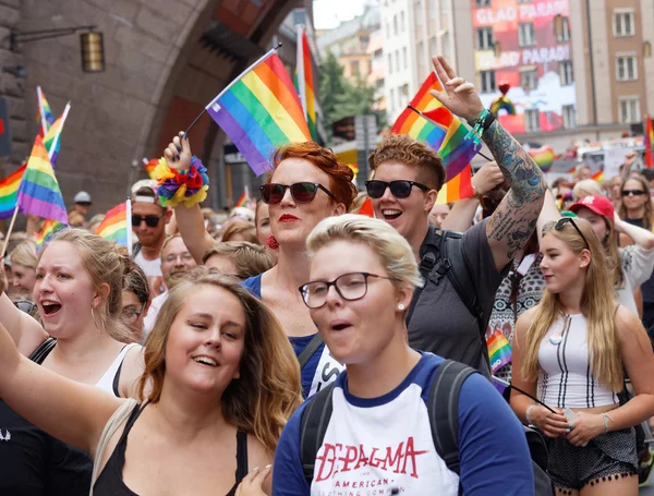 Dziewcząt i chłopców, zrzekając się tęczowymi flagami duma w Pride para — Zdjęcie stockowe