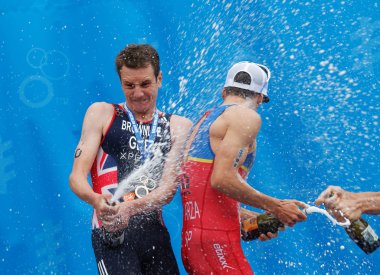 STOCKHOLM - JUL 02, 2016: The medalist triathletes Alistair Brownlee and Pierre Le Corre squirting champagne on the podium in the Men's ITU World Triathlon series event July 02, 2016 in Stockholm, Sweden