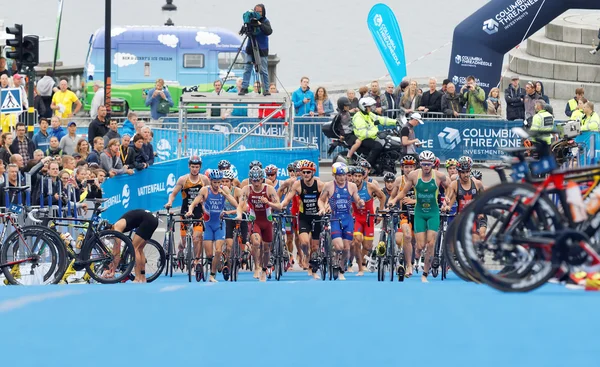 Grote groep van het runnen van triatleten met bicyles in de t — Stockfoto