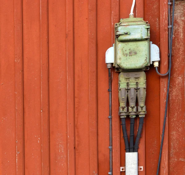 Electric junction boxes, retro style on red wall-2 — Stock Photo, Image