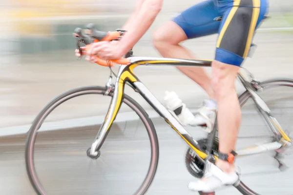 Rapid blue bicycling man, sideview without torso