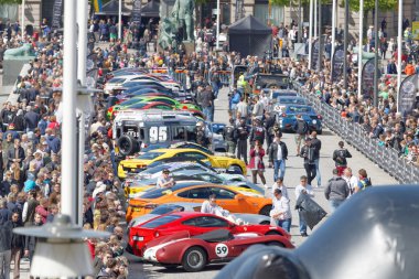 Fast sports-cars before the start of the public event Gumball 30 clipart