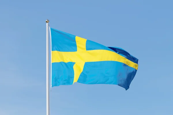 Swedish flag, blue and a yellow cross, blue sky — Stockfoto