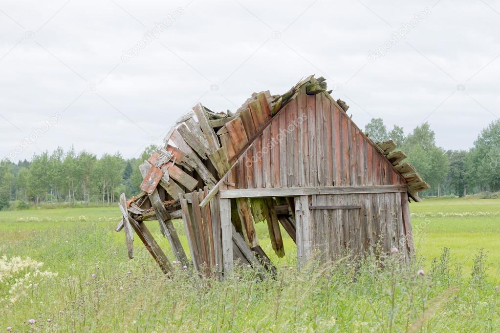 Tumbledown barn on a field