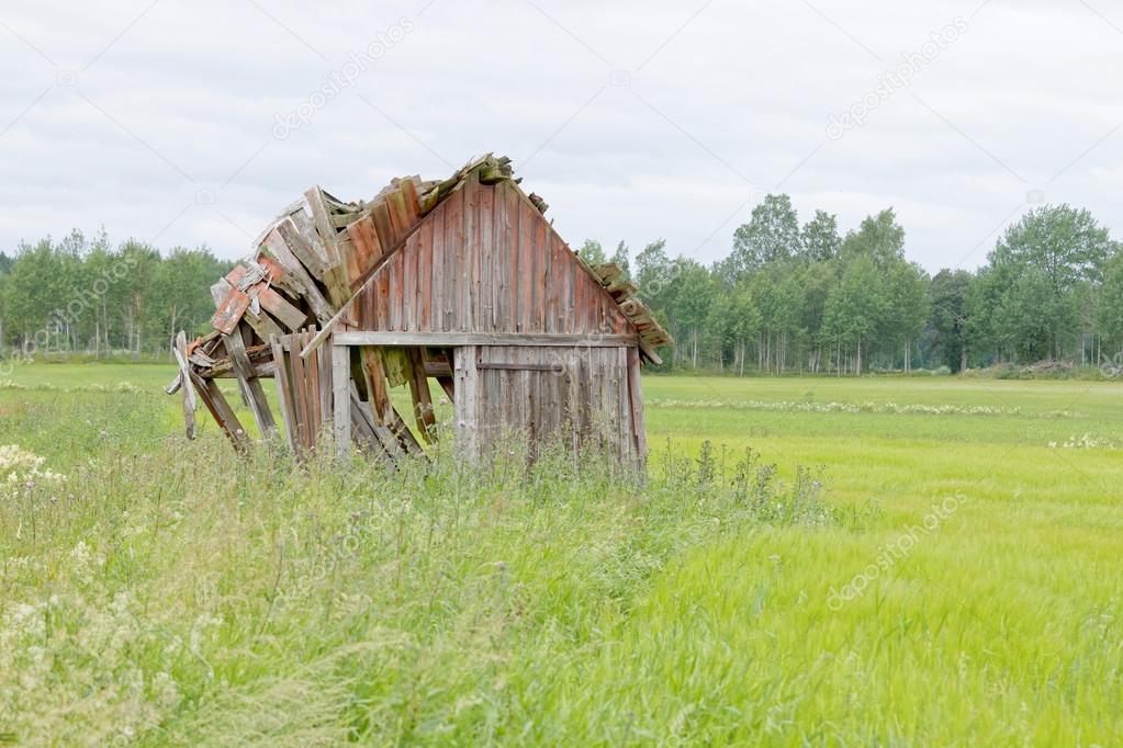 Tumbledown barn on a field