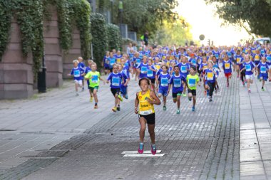 Girl in the lead followed by running competitors clipart