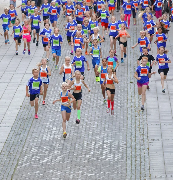 Large group of running girls and boys in blue — Stock Photo, Image