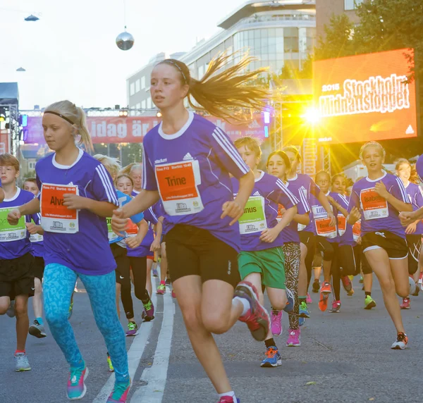 Group of running girls in blue dresses — Stock Photo, Image