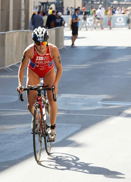 Triathlete Elena Danilova standing up cycling — Stock Photo, Image
