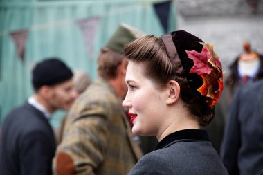 Smiling girl in profile wearing old fashioned tweed clothes clipart