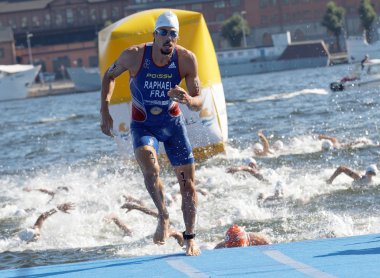 Swimmer Aurelien Raphael (FRA) climbing up from the water