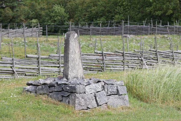 Mile stone in farm land — Stock Photo, Image