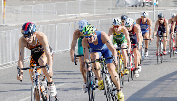 Group of male cycling triathlon competitors fighting