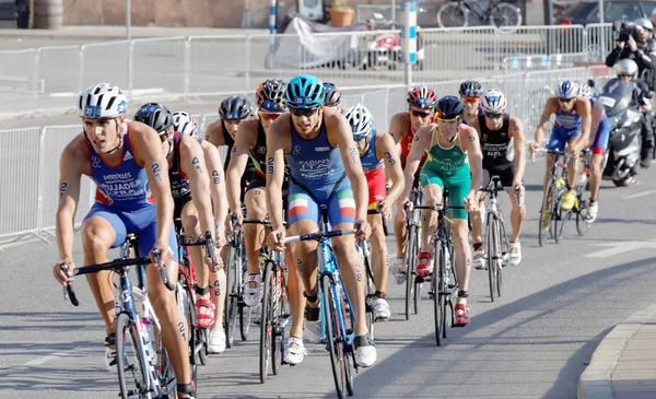 Group of male cycling triathlon competitors fighting — Stock Photo, Image