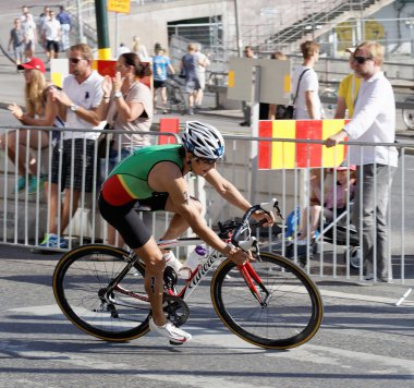 STOCKHOLM, SWEDEN - AUG 23, 2015: Side view of cycling triathlon athlete Juao Silva in a curve in the Men's ITU World Triathlon series event August 23, 2015 in Stockholm, Sweden