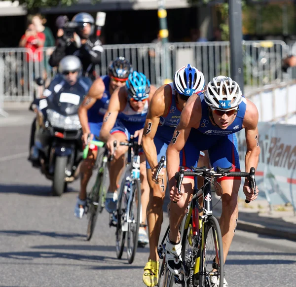 STOCKHOLM, SWEDEN - AUG 23, 2015: Igor Polyanskiy followed of a group of cycling triathlon competitors in the Men's ITU World Triathlon series event August 23, 2015 in Stockholm, Sweden