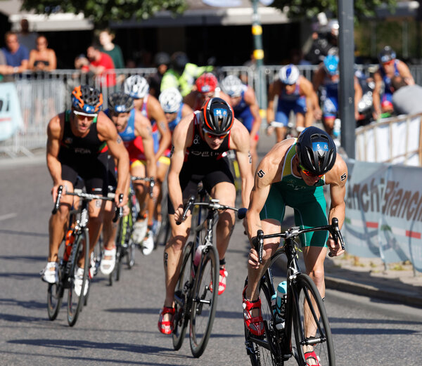 STOCKHOLM, SWEDEN - AUG 23, 2015: Large group of muscular cycling triathlon competitors fighting in the Men's ITU World Triathlon series event August 23, 2015 in Stockholm, Sweden