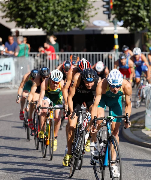 Large group of cycling triathlon competitors fighting — Stock Photo, Image