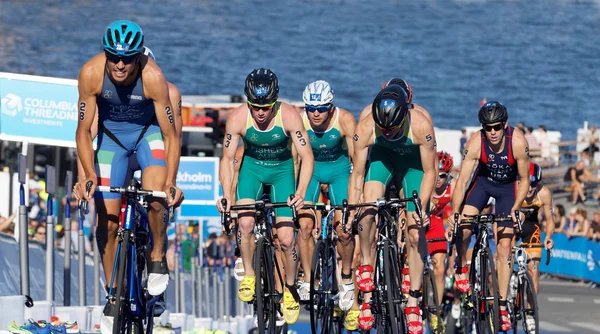 Group of triathlon competitors cycling uphill — Stock Photo, Image