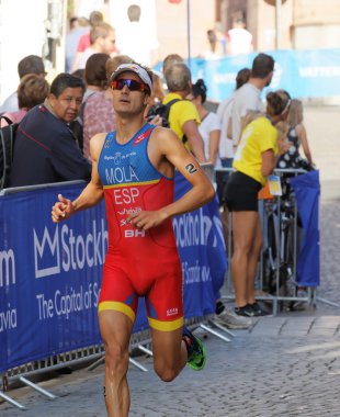 STOCKHOLM, SWEDEN - AUG 23, 2015: Winning triathlete Mario Mola (ESP) running on cobblestone in the Men's ITU World Triathlon series event August 23, 2015 in Stockholm, Sweden