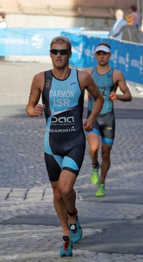 STOCKHOLM, SWEDEN - AUG 23, 2015: Triathlete Ron Darmon  running wearing sun glasses in the Men's ITU World Triathlon series event August 23, 2015 in Stockholm, Sweden