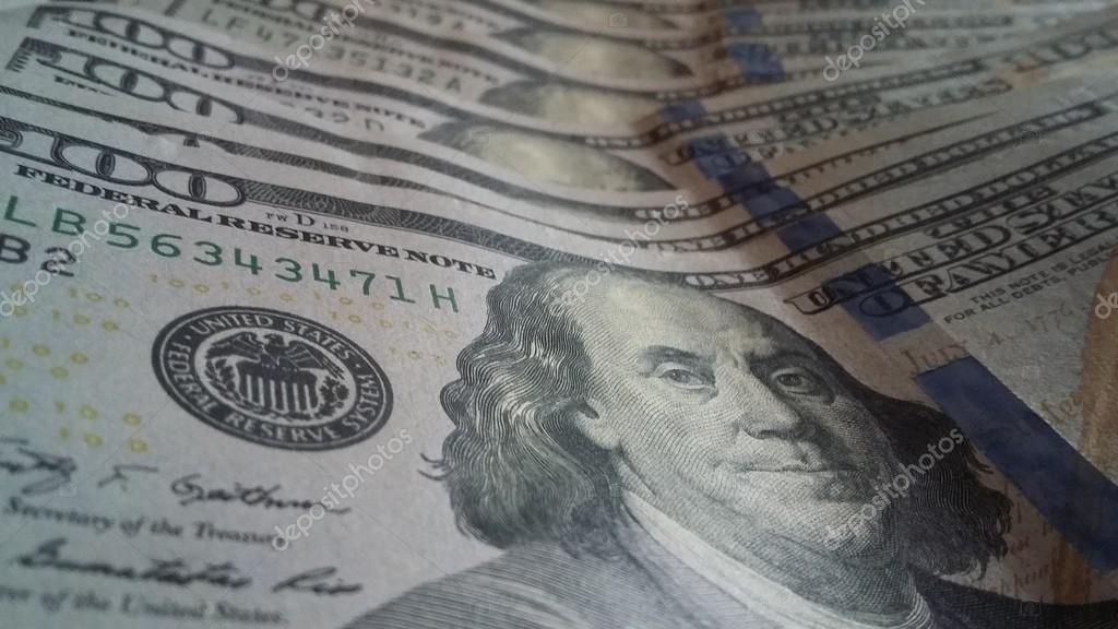 Closeup of new hundred dollars bills stack from front side