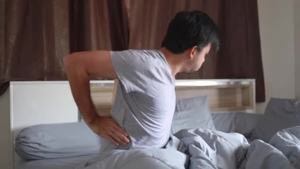 Young Asian Man Back Pain Bed Home Health Problems — Stock Video