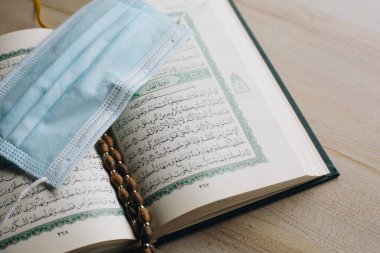 Holy Book of Quran With Rosary and Face mask, Ramadan concept, Islamic religious ritual
