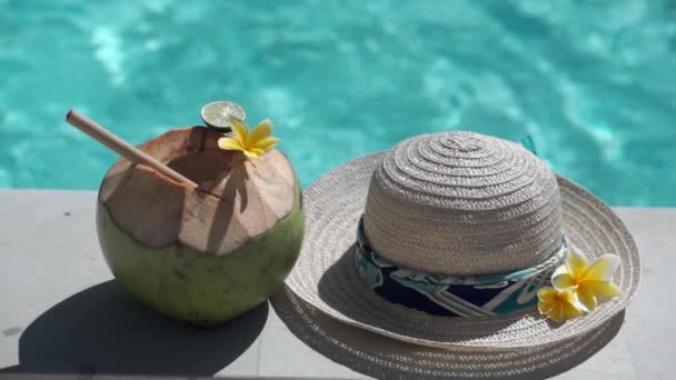 在巴厘岛 绿色的椰子与竹杆 太阳帽 热带黄花 游泳池边的棕榈树荫紧密相连的视频镜头 — 图库视频影像