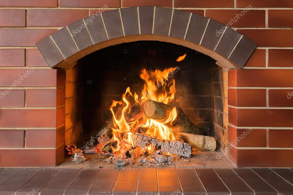 Wood burning fireplace in a bright fire Stock Photo by ©dimetradim 108043424