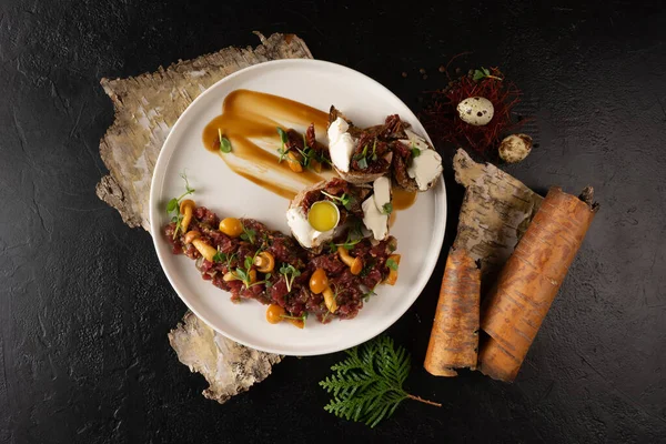 Veal tartare with pickled mushrooms and bruschetta with cream cheese, beef and quail egg. Cold raw meat dish with mushrooms. — Stock Image Veal Tartare Pickled Mushrooms Bruschetta Cream Cheese Beef Quail Egg Stock Image