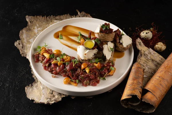 Veal tartare with pickled mushrooms and bruschetta with cream cheese, beef and quail egg. Cold raw meat dish with mushrooms. — Stock Image Veal Tartare Pickled Mushrooms Bruschetta Cream Cheese Beef Quail Egg Stock Image