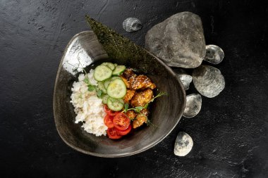 Teriyaki tavuğu, pilav ve sebzeli. Tavuk fileto, haşlanmış pilav, salatalık ve domatesle ana yemek, susam tohumlarıyla süslenmiş, nori ve taze bezelye filizleri..