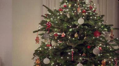 Noel ağacı zencefilli kurabiye adam süslemeleri, beyaz takılar ve oturma odasının içinde parıldayan LED lambalarla süslenmiş. Metin iletisi için negatif kopya alanı olan şenlikli tatil arkaplanı.