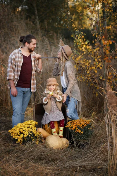 family of farmers at the harvest in autumn