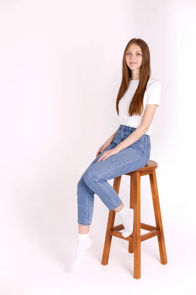 Ung Kvinna Vit Shirt Och Jeans Sitter Stol Vit Isolerad — Stockfoto