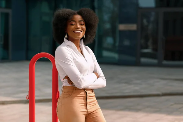 Attractive black woman smiling in town