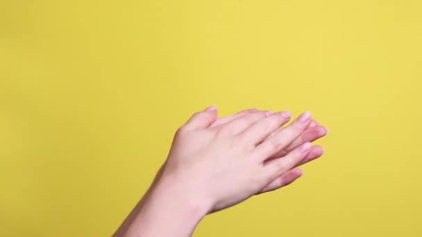 Woman Rubbing Her Hands Cream Yellow Background — Vídeo de Stock