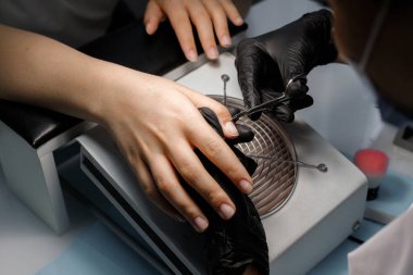 manicure of hands in the beauty salon at the master