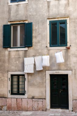 Eski kasabada ahşap panjurlu bir bina.