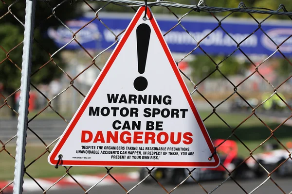 Warning Sign - Motorsport can be dangerous — Stock Photo, Image