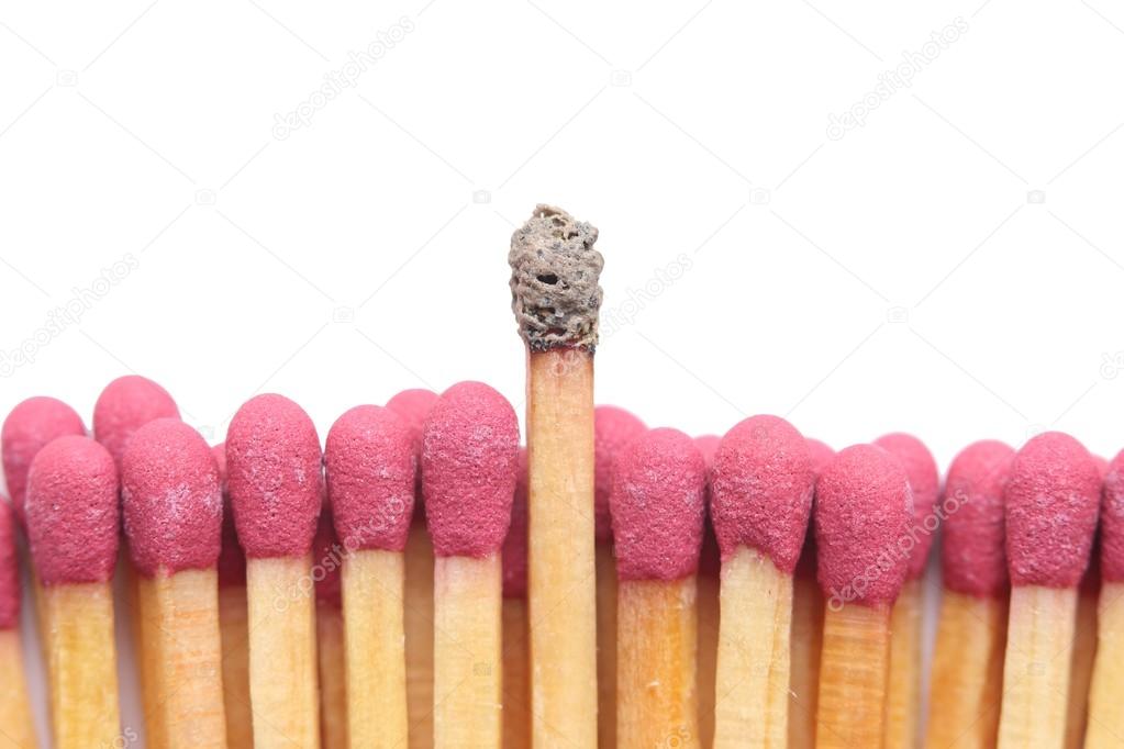 Row of matches with one standing out