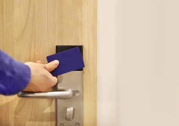 Electronic lock on door.man opening hotel room electronic lock with key card