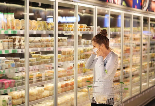 supermarket shopping, face mask and gloves,Woman choosing a dairy products at supermarket