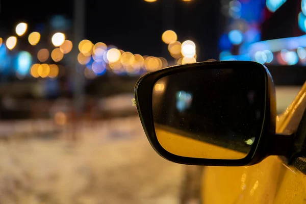 car side mirror on the background lights of the city. high quality